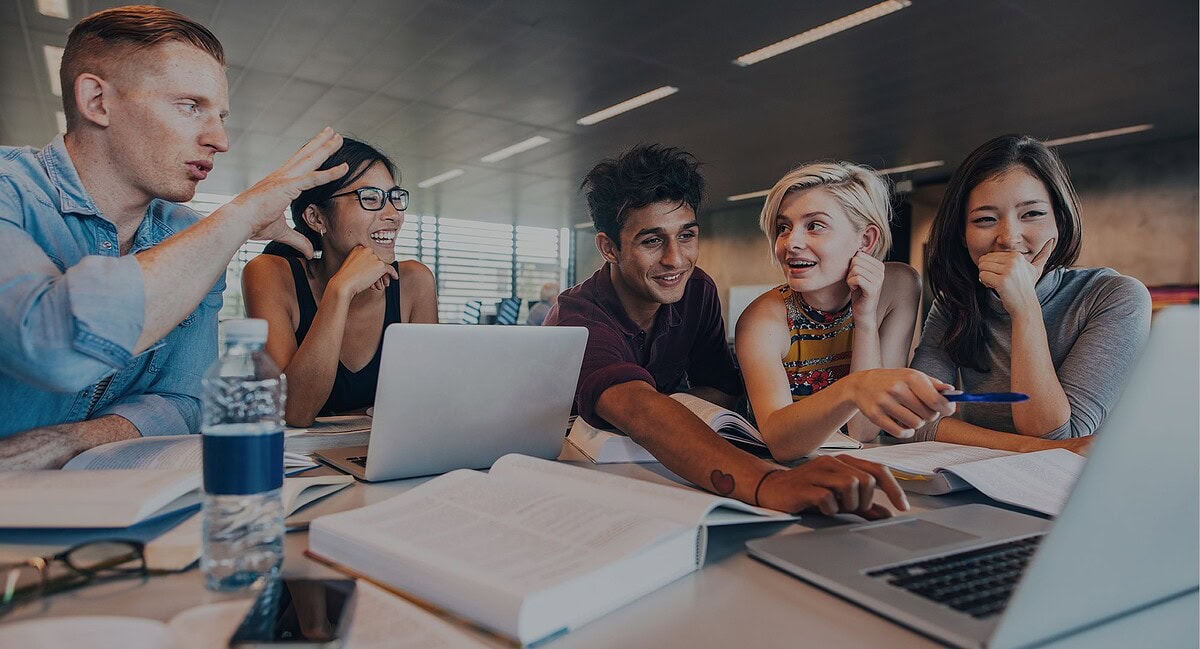 Diverse team of young professionals collaborating on a tech project in a modern office.