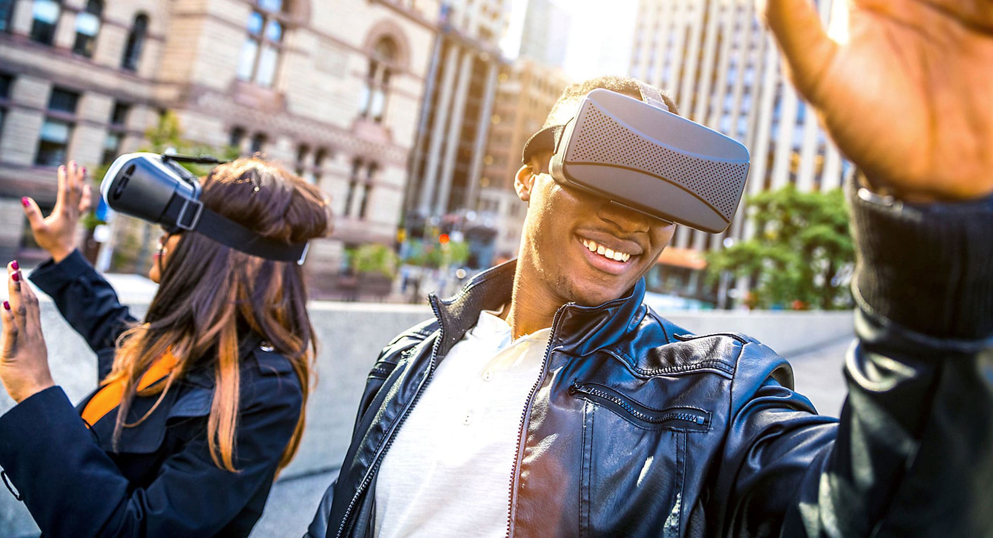 VR headset in use by a smiling man in an urban setting.