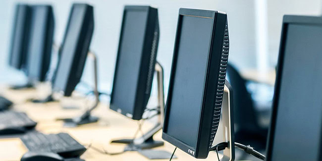 Modern computer workstations in a tech lab environment at Softinator TechLabs.