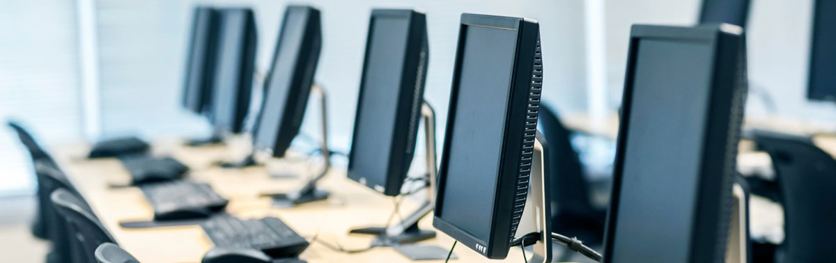 Modern computer workstations in a tech lab environment at Softinator TechLabs.