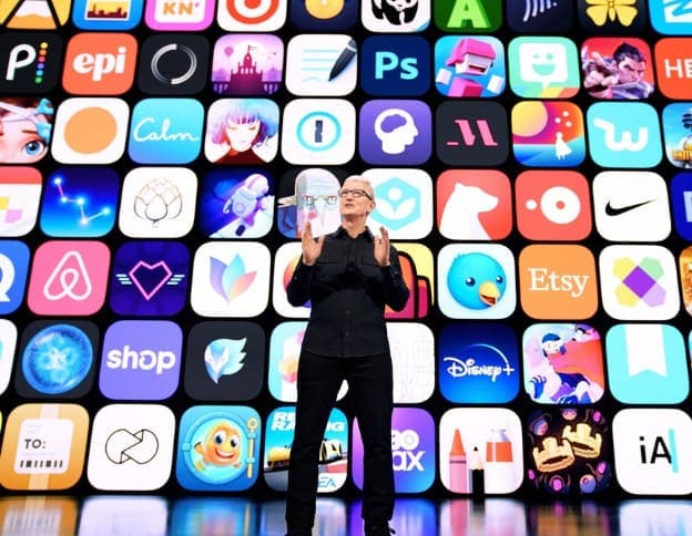 Expert discussing mobile app development with a colorful app icons background.