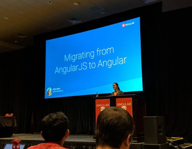 Speaker presenting on migrating from AngularJS to Angular at a tech conference.