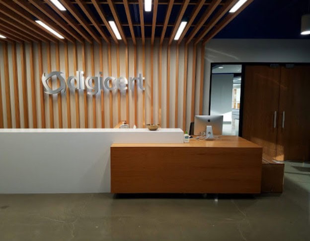 Modern office reception with Softinator TechLabs logo and wooden decor.