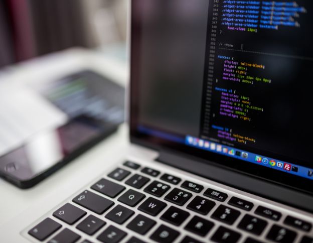 Coding on a laptop screen showcasing AI and ML frameworks and libraries.