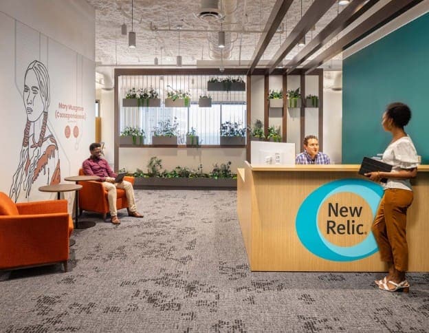 Modern office reception with seating and greenery at Softinator TechLabs.