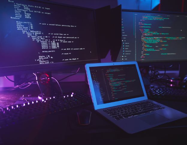 Advanced coding environment with multiple screens displaying code and development tools.