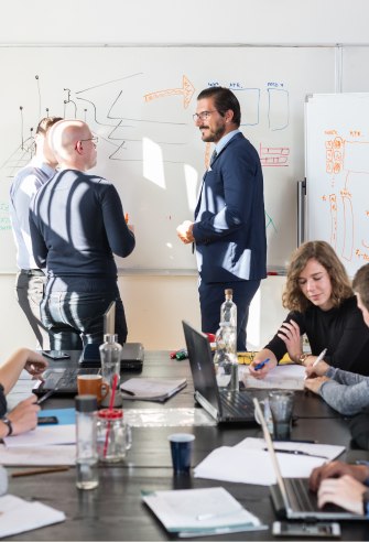AI and ML development team collaborating in a tech-focused meeting.