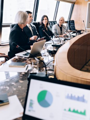 Business team discussing technology strategies in a modern conference room.