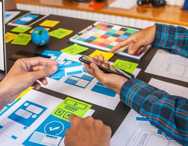 Wireframing and prototyping process for app development using sketches and digital tools.