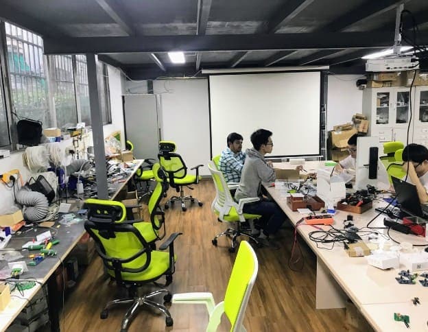 IoT devices and hardware development workspace with engineers working on prototypes.