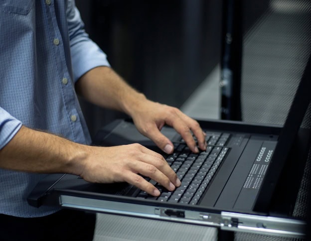 AI and ML developer working on a laptop at Softinator TechLabs.