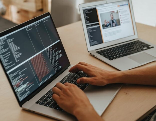 Developer testing AI software on laptops for specialized testing processes.