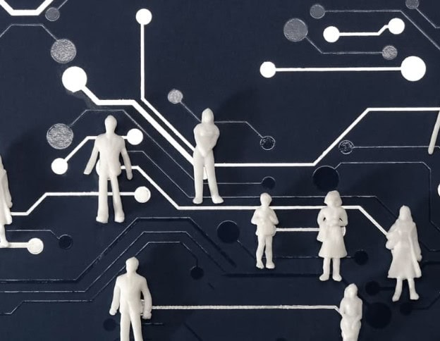 Figurines representing customer journey mapping on a tech circuit background.