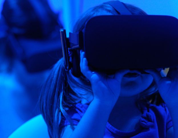Child using VR headset for digital innovation and immersive experiences.