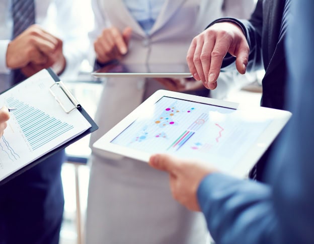 Business team discussing static and dynamic application testing on tablets.