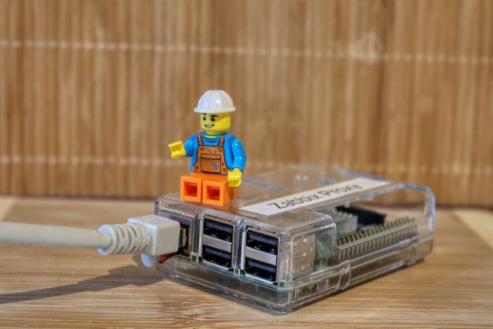 Lego figure on IoT device representing IoT security and technology.