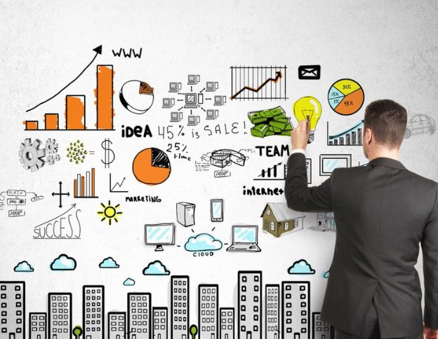 Businessman analyzing multi-cloud strategy diagrams and charts on a whiteboard.