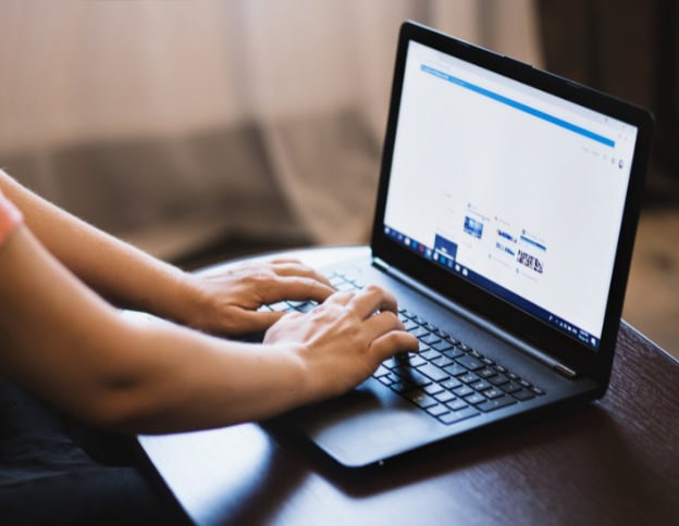 Person working on a laptop with SEO tools open for on-page SEO analysis.