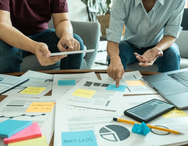 Team discussing organizational change strategies with documents and charts.