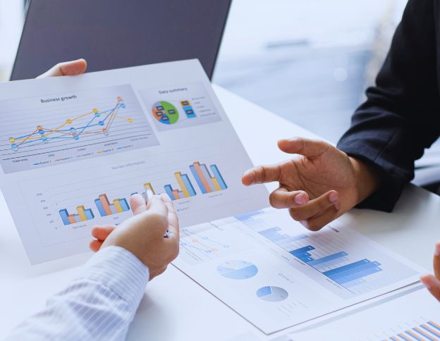 Business professionals discussing risk management data and charts.