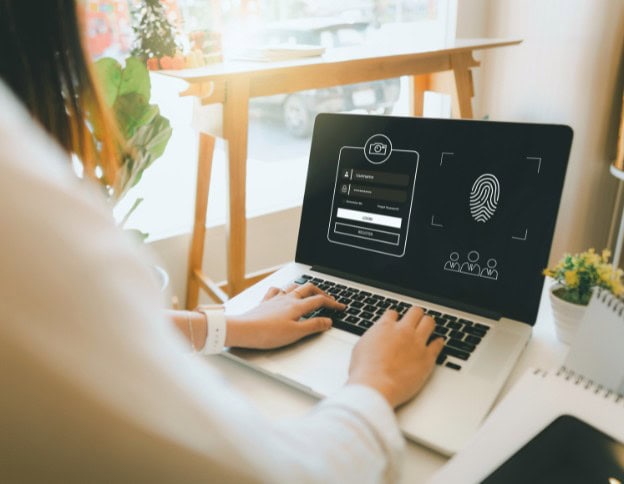 SIEM system monitoring cybersecurity events on a laptop screen.