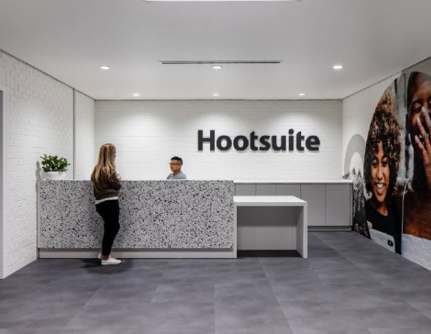 Reception area at Softinator TechLabs with the Hootsuite logo in the background.