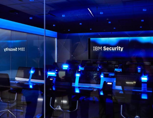 Modern IBM security conference room with digital security displays.