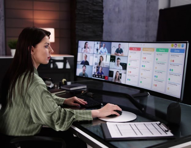 Remote technical support team managing multiple video calls and support tickets on dual monitors.