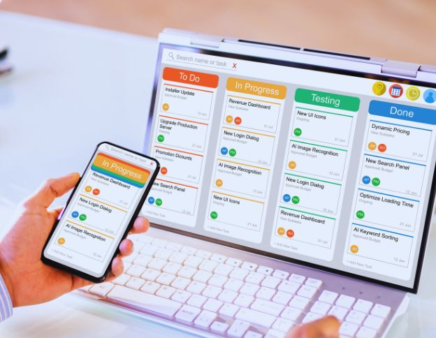 AI project management dashboard on laptop and smartphone.