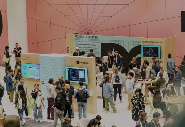 Softinator TechLabs booth showcasing mobile app solutions at a tech event.