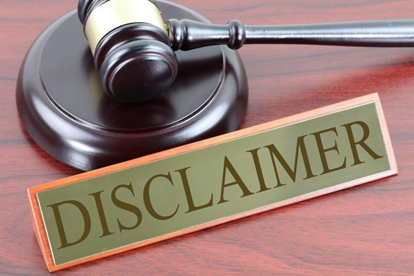 Gavel and "Disclaimer" sign on wooden surface.