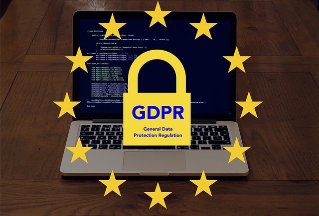 GDPR policy concept with a laptop displaying data security and protection symbols.