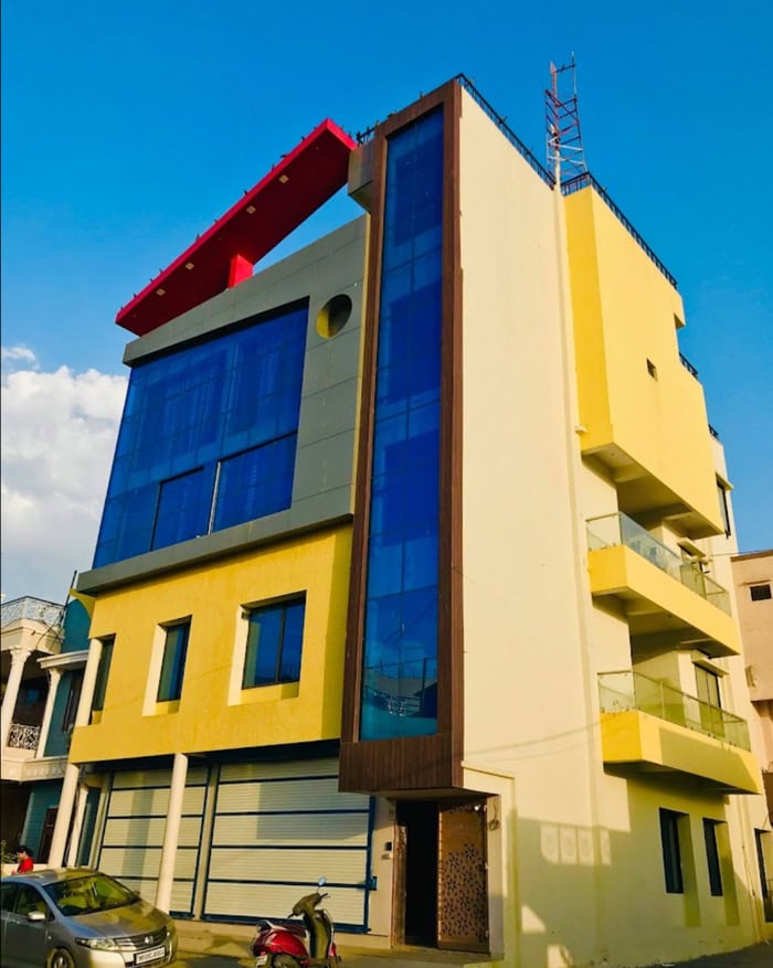 Contemporary building with vibrant yellow, red, and blue accents, featuring large glass windows and.