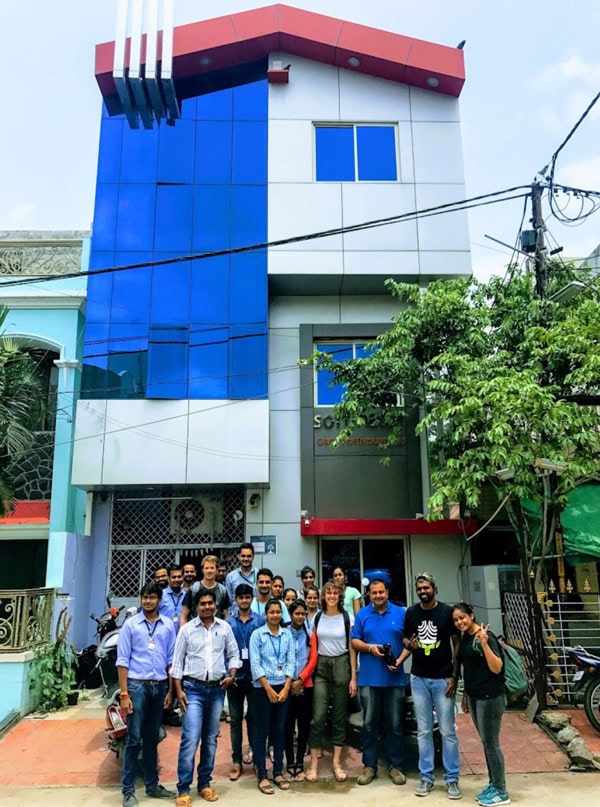 Softinator TechLabs building with team of professionals outside, showcasing AI and ML expertise.