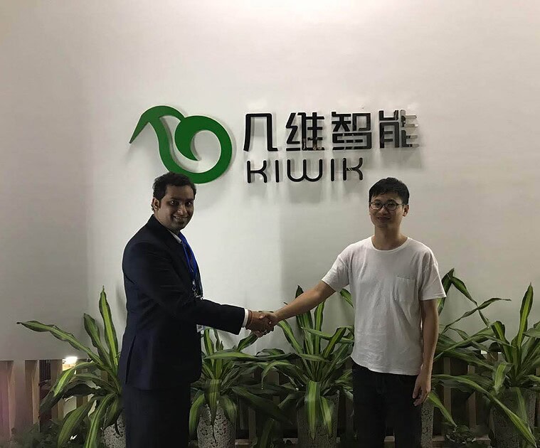 Two men shaking hands in front of Softinator logo at TechLabs event.