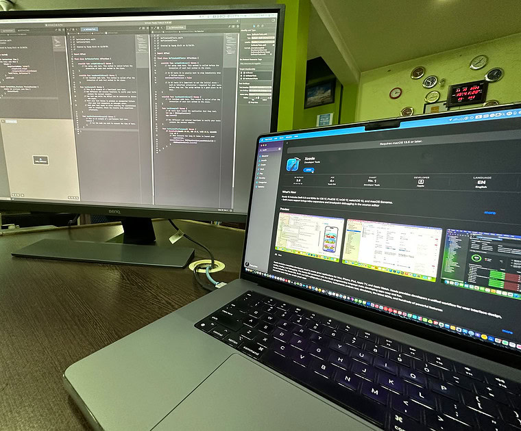 Developer working on Android app code on dual screens at Softinator TechLabs.