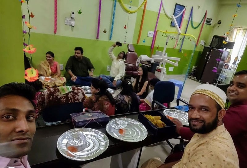 Team gathering at Softinator TechLabs celebrating diversity and inclusion in a vibrant workspace.