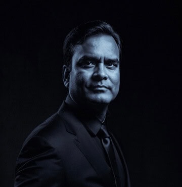 Professional male team leader in a dark suit for Softinator TechLabs.