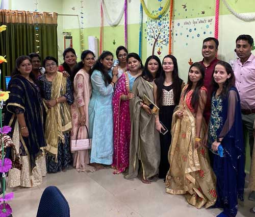 Softinator team celebrating at a festive event in colorful traditional attire.