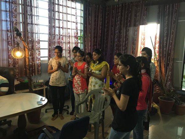 An energetic group of women collaborating in a cozy office space at Softinator TechLabs.