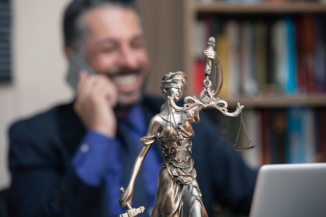 Businessman holding a justice statue symbolizing rights and responsibilities in technology.